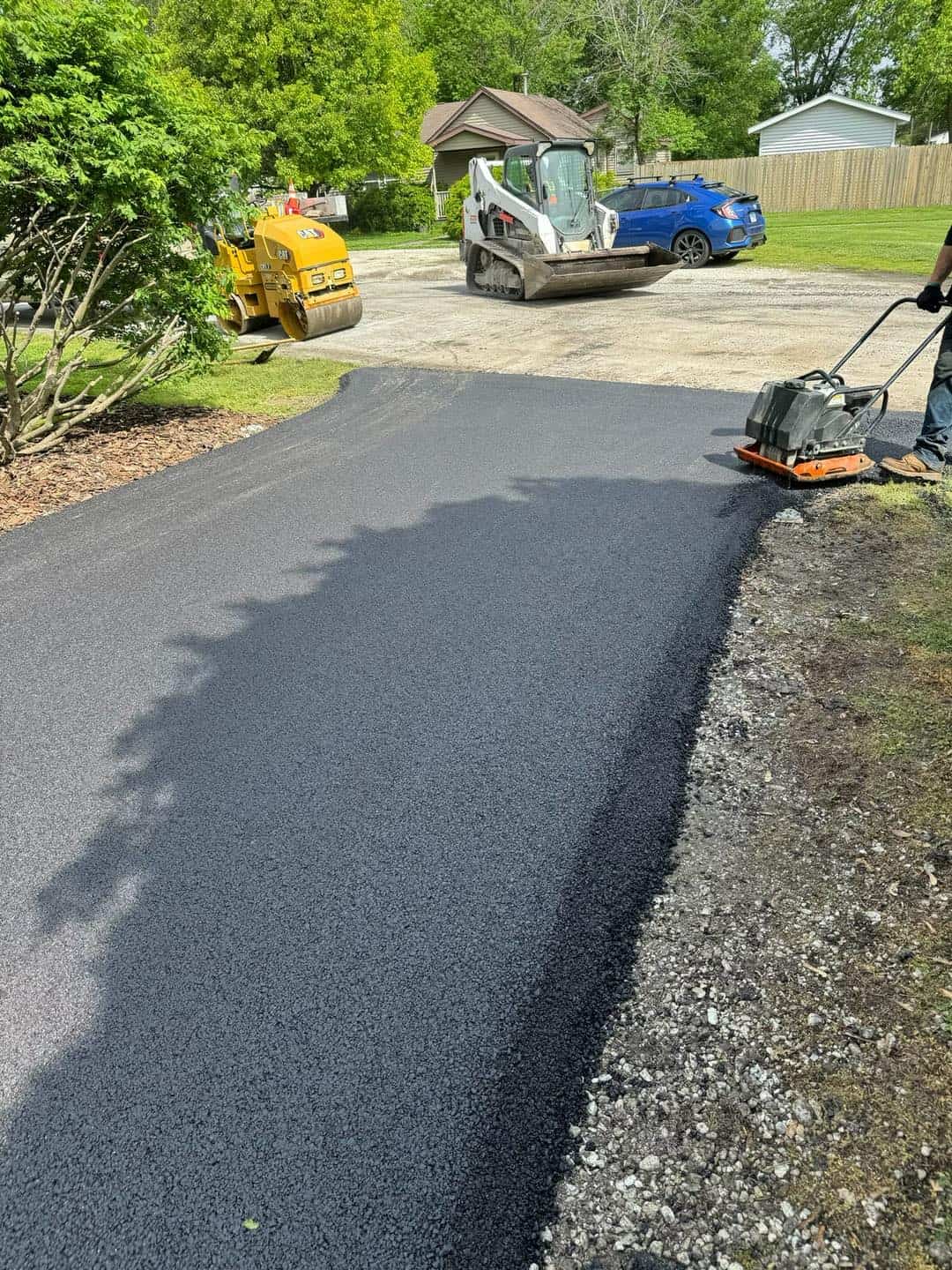 Compactor finishing a driveway