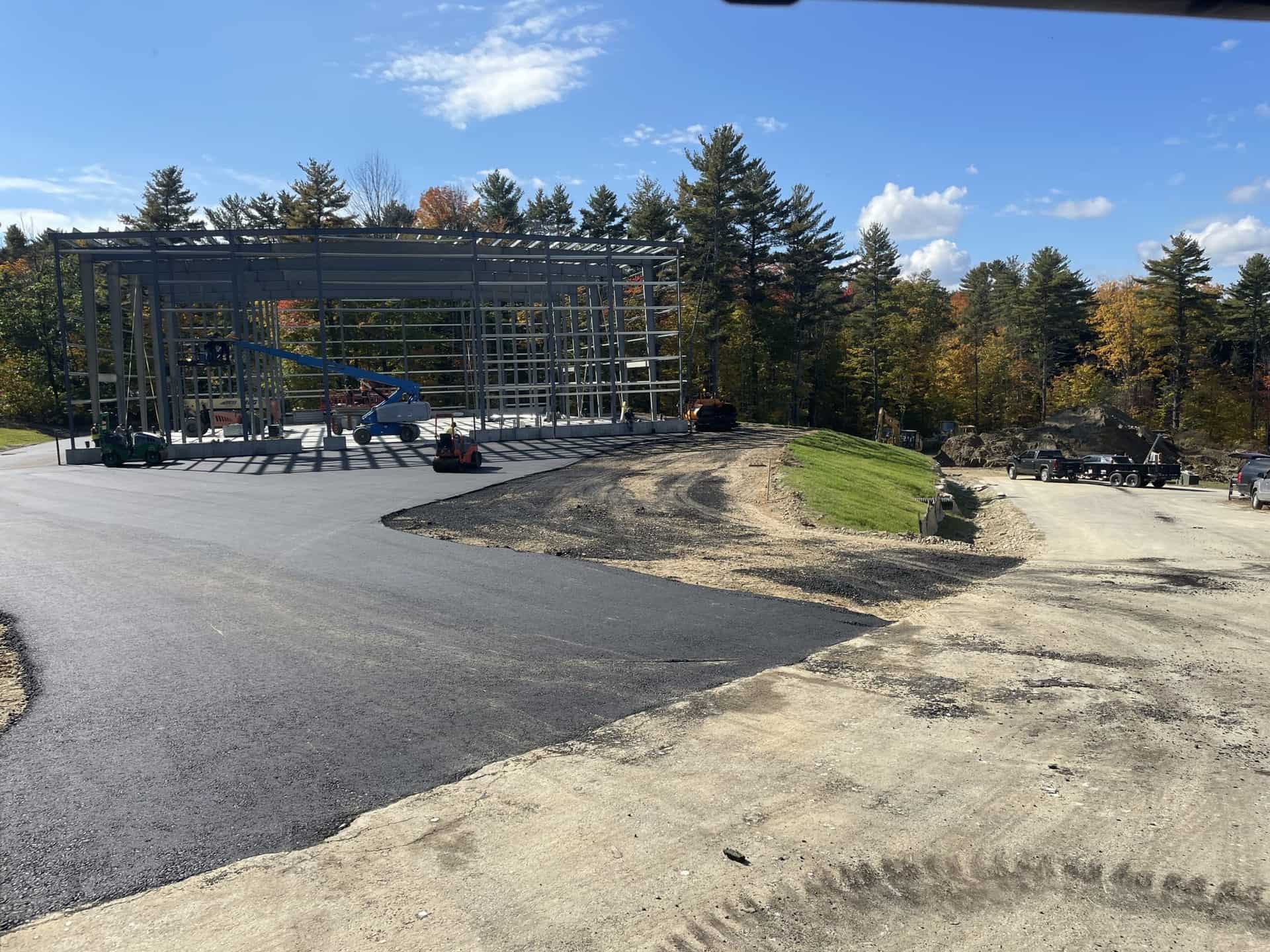 Industrial asphalt paving near a steel frame building