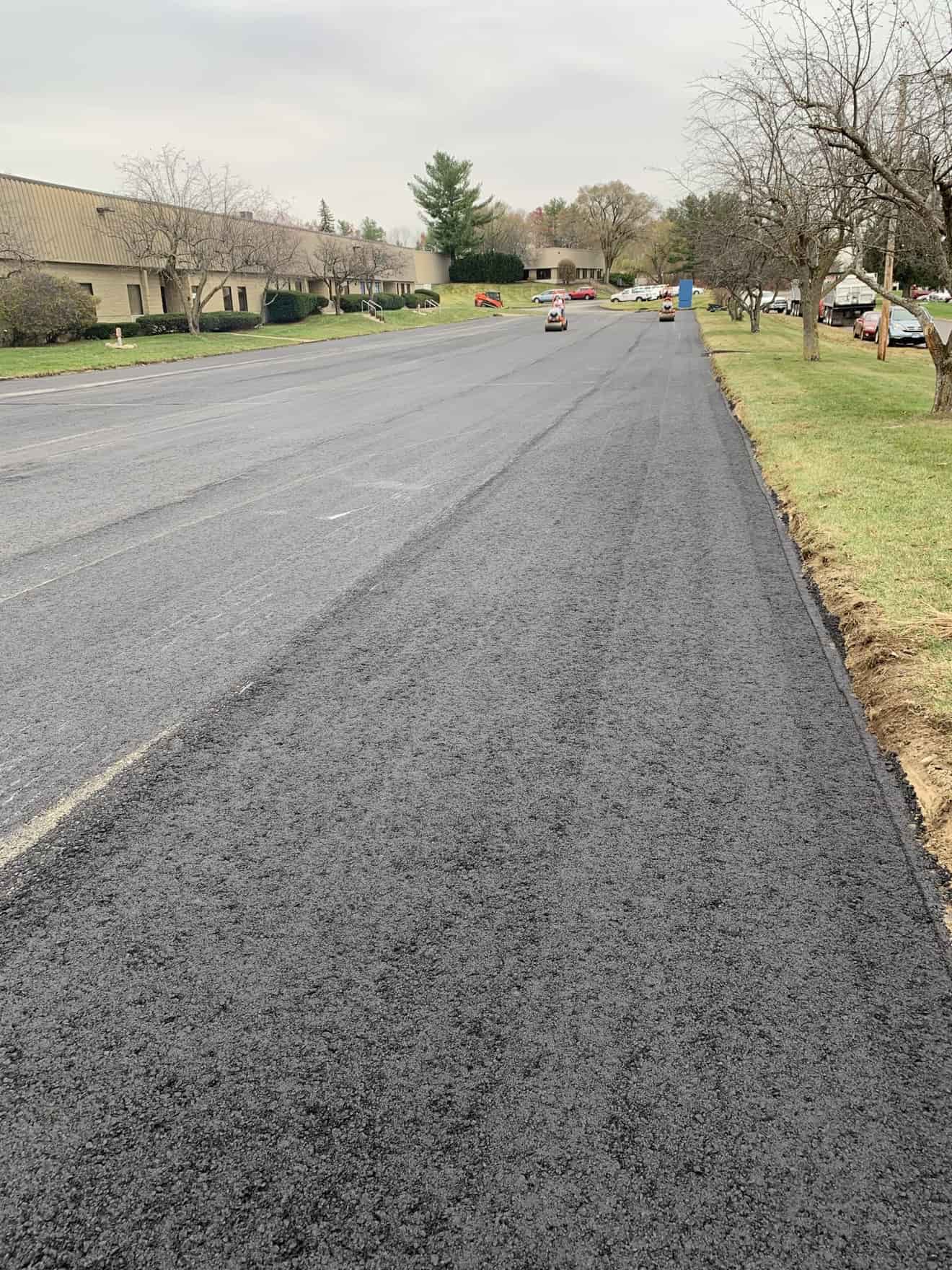 Asphalt resurfacing with rollers finishing an overlay